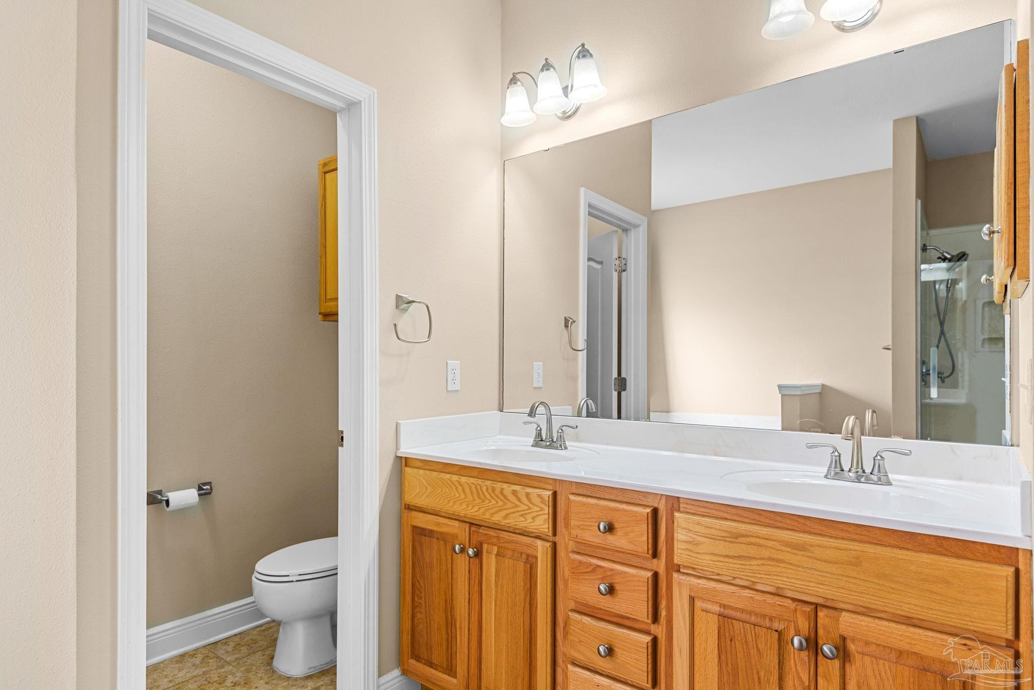 1007 Patriot Place Pensacola, FL 32534 - Photo 25 of 40 a bathroom with a granite countertop sink toilet and shower