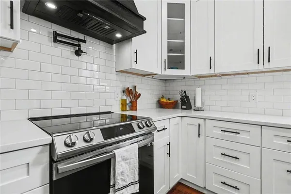 a utility room with dryer washer and a view of living room