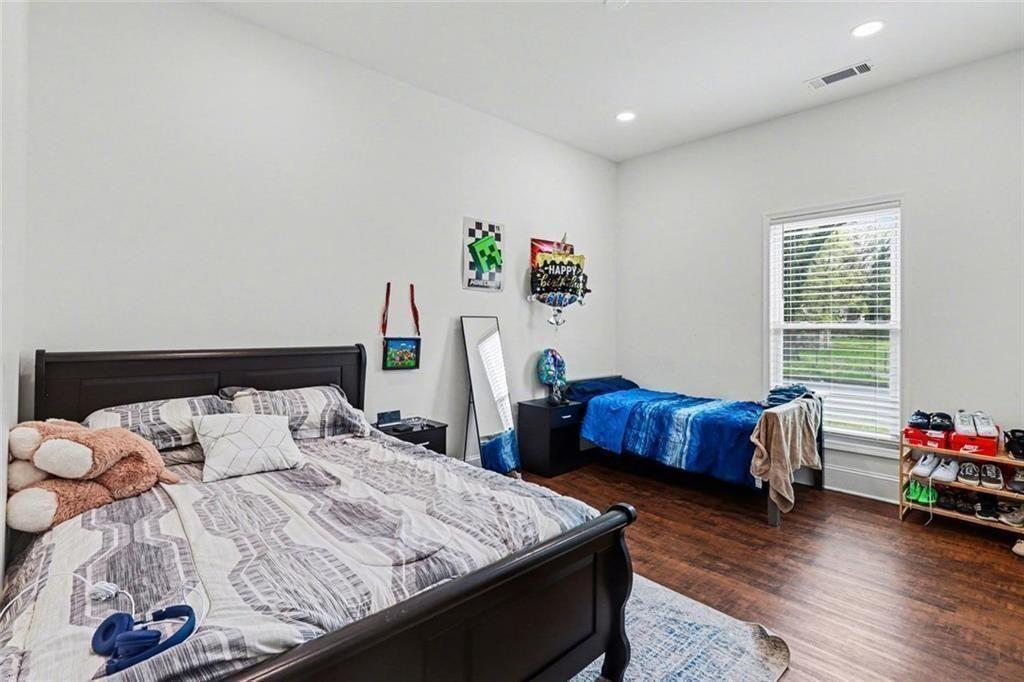 417 Pennington Avenue Southwest Rome, GA 30161 - Photo 16 of 30 a bedroom with a bed and a wooden floor