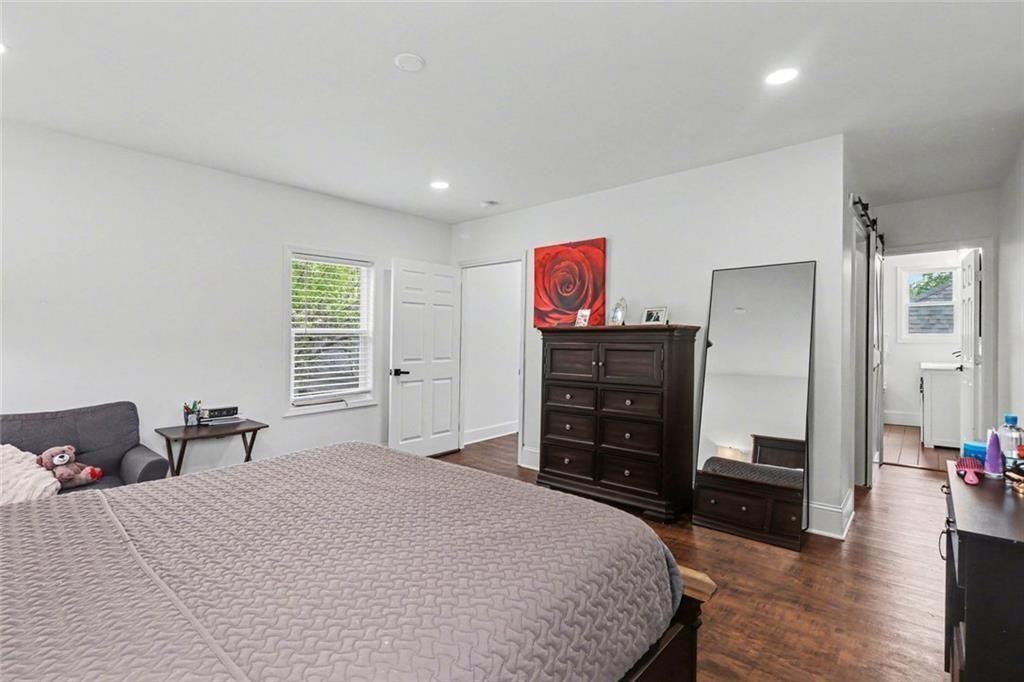 417 Pennington Avenue Southwest Rome, GA 30161 - Photo 23 of 30 a bedroom with a bed and dresser with mirror
