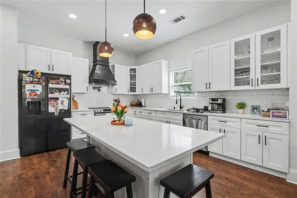 a kitchen with stainless steel appliances a sink a stove and a window