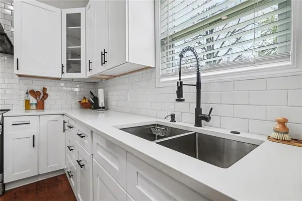 a stove top oven sitting inside of a kitchen