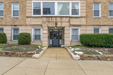 a view of a brick building next to a yard