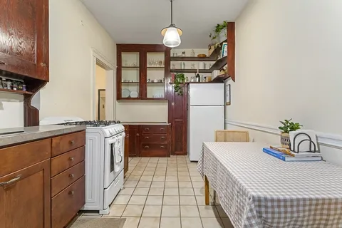 a kitchen that has a lot of cabinets and a stove