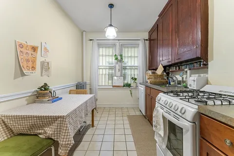a kitchen with a stove window and cabinets