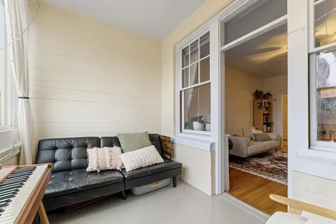 a view of room with window and wooden floor