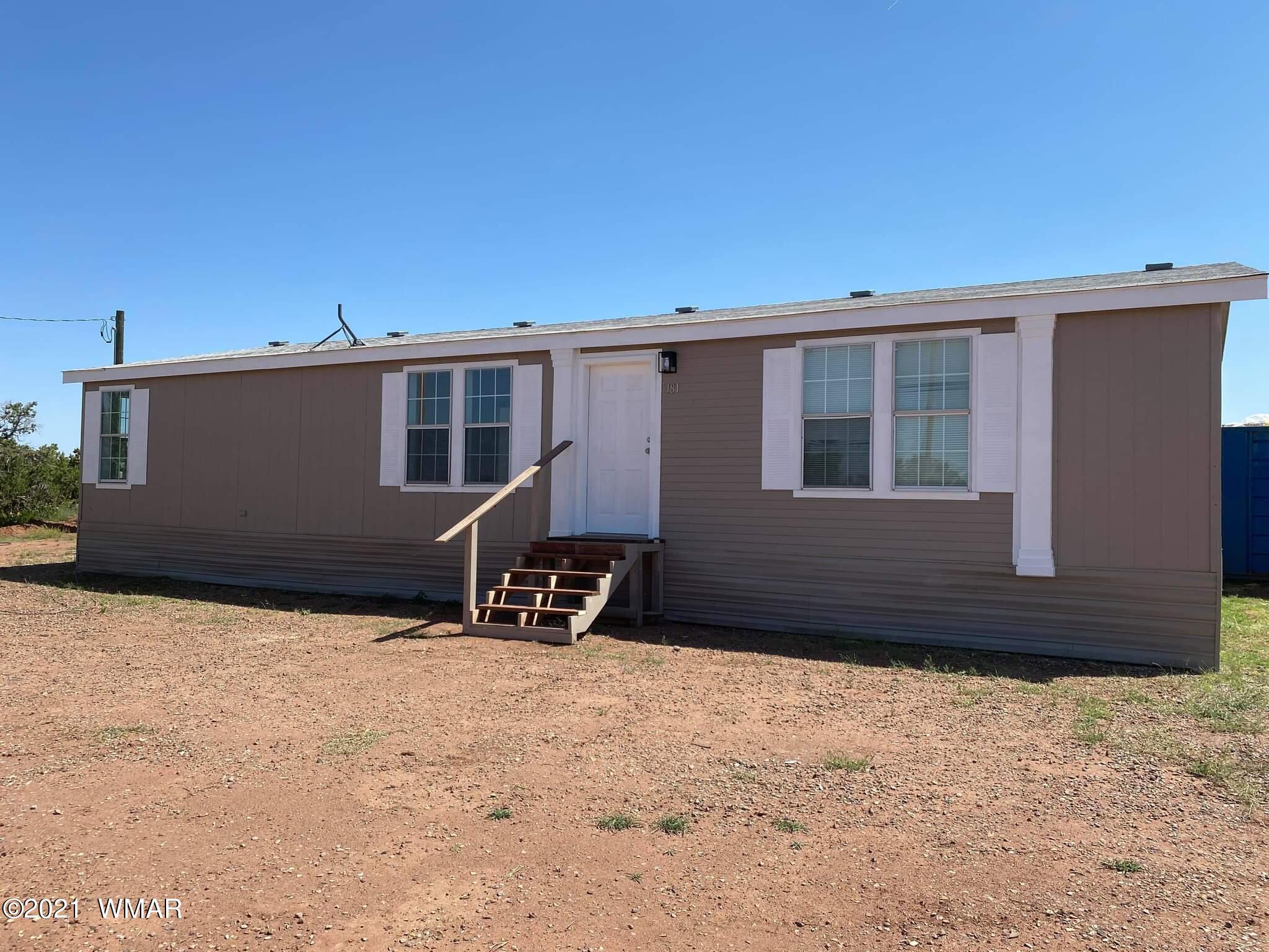 181 River Spings Ranch St. Johns, AZ 85936 - Photo 1 of 60 a front view of a house with a yard