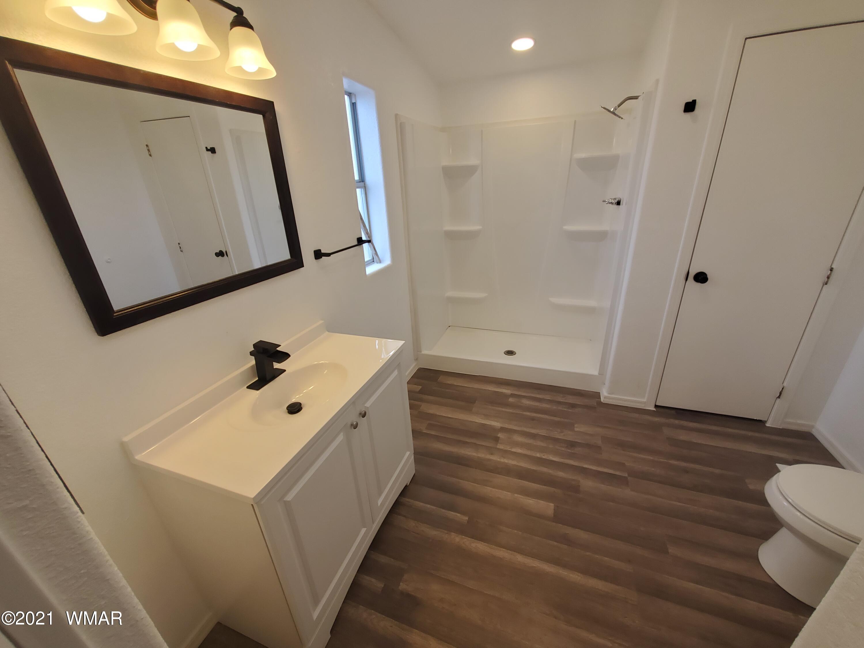 181 River Spings Ranch St. Johns, AZ 85936 - Photo 13 of 60 a bathroom with a sink a toilet and mirror