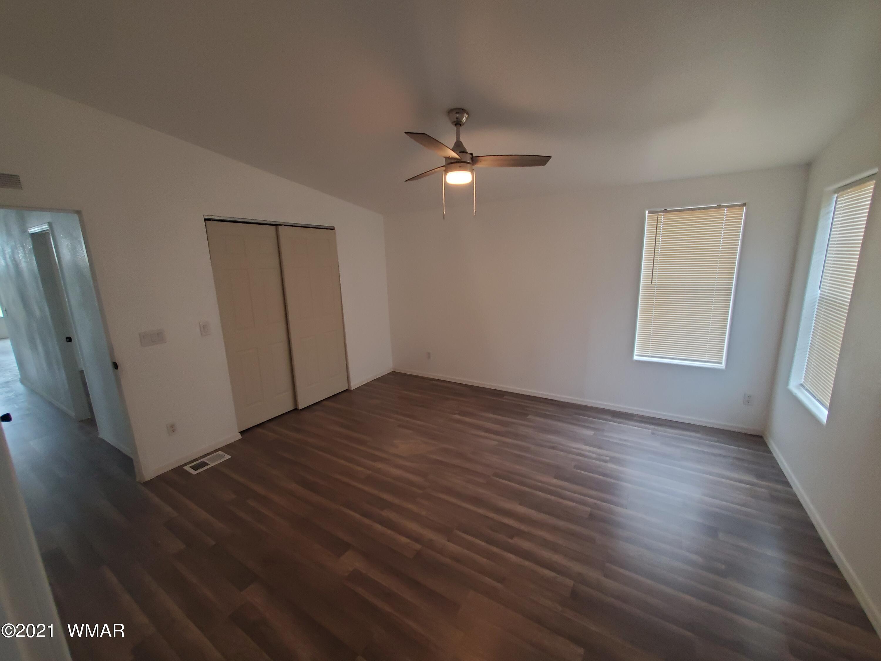 181 River Spings Ranch St. Johns, AZ 85936 - Photo 16 of 60 a view of empty room with wooden floor and fan