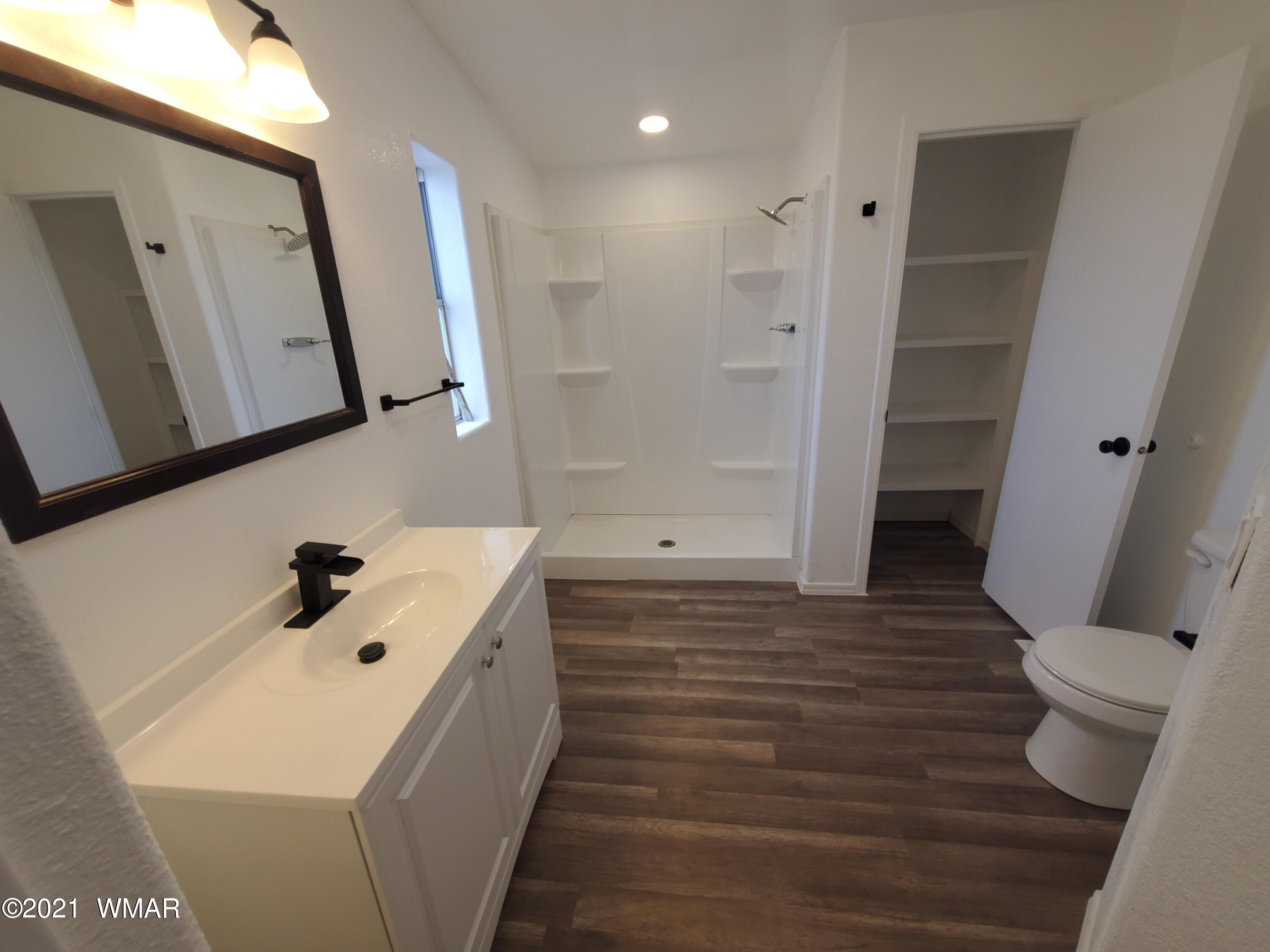 181 River Spings Ranch St. Johns, AZ 85936 - Photo 19 of 60 a bathroom with a sink a toilet and mirror