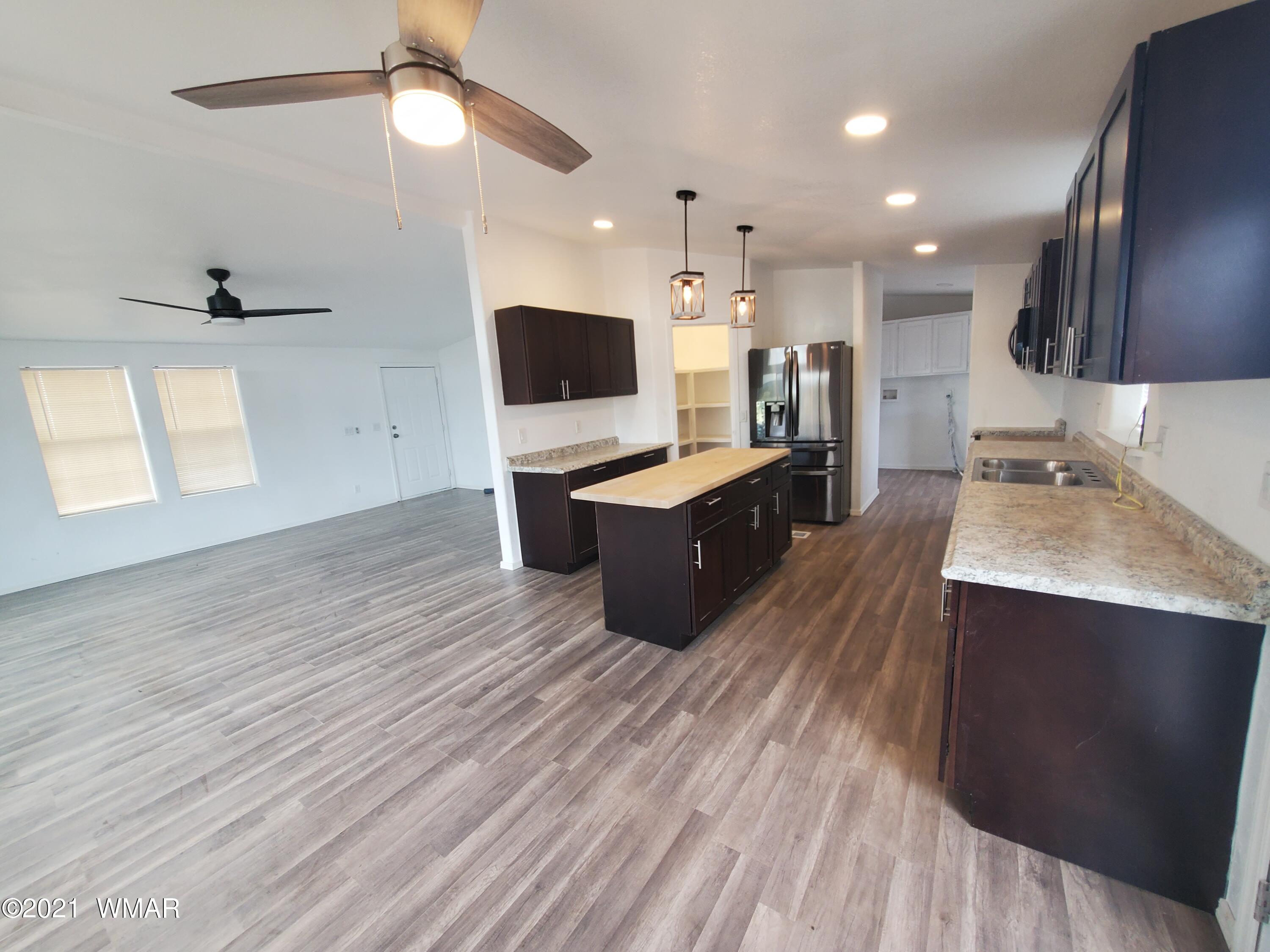 181 River Spings Ranch St. Johns, AZ 85936 - Photo 2 of 60 a large kitchen with cabinets a sink and a stove