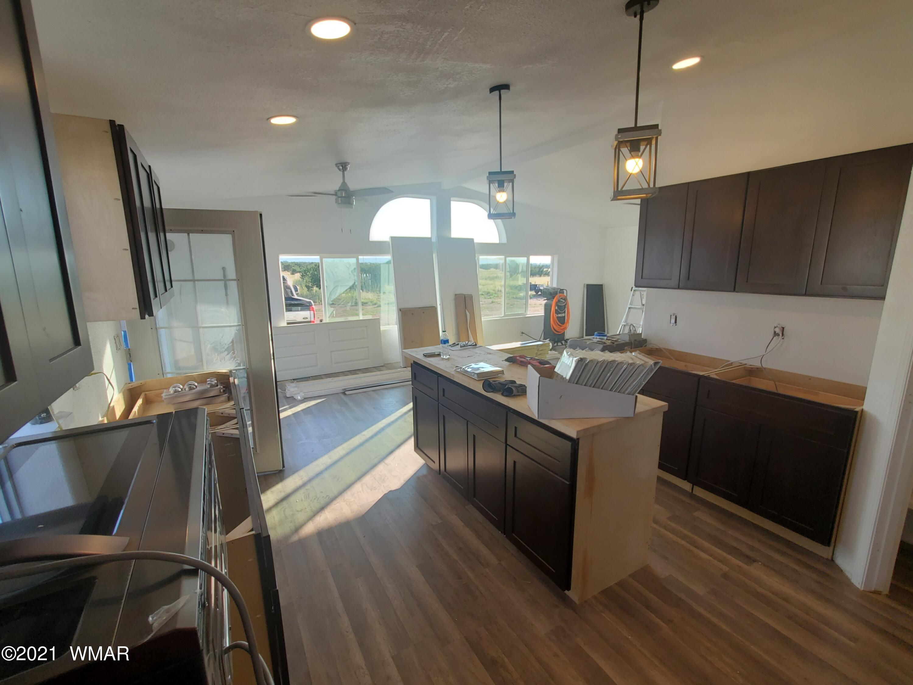 181 River Spings Ranch St. Johns, AZ 85936 - Photo 26 of 60 a kitchen with stainless steel appliances granite countertop a sink a stove and a wooden floor