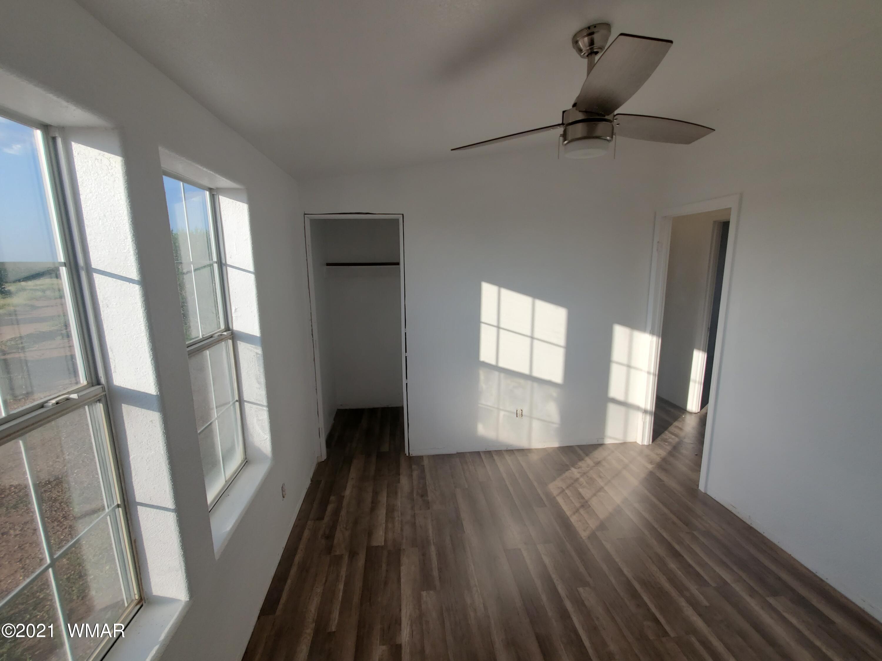 181 River Spings Ranch St. Johns, AZ 85936 - Photo 32 of 60 a view of an empty room with wooden floor and a window