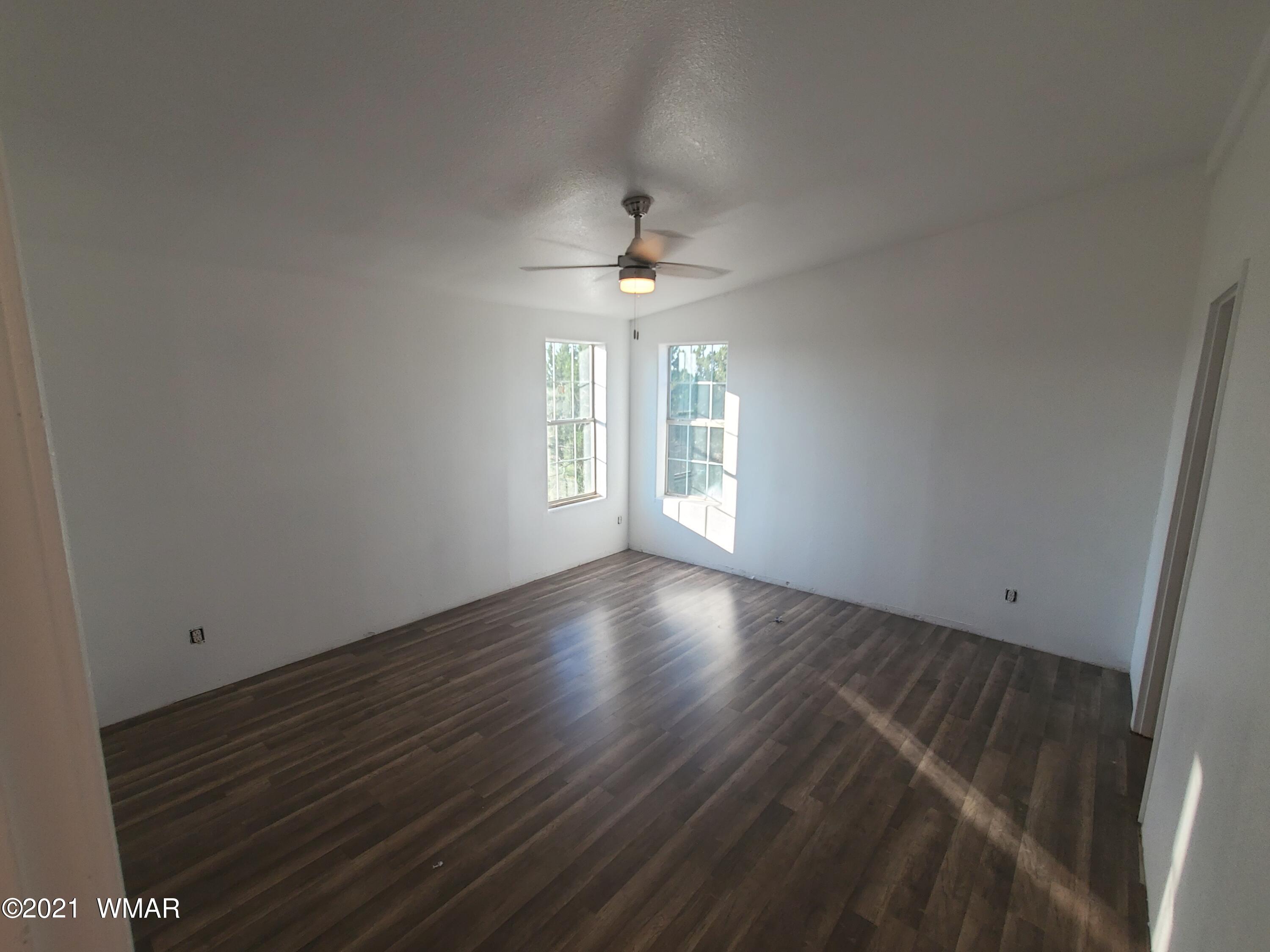 181 River Spings Ranch St. Johns, AZ 85936 - Photo 33 of 60 wooden floor in an empty room with a window