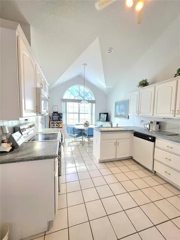 a kitchen with stainless steel appliances kitchen island granite countertop a sink and cabinets