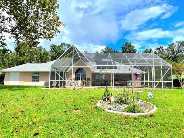 a front view of a house with a yard table and chairs