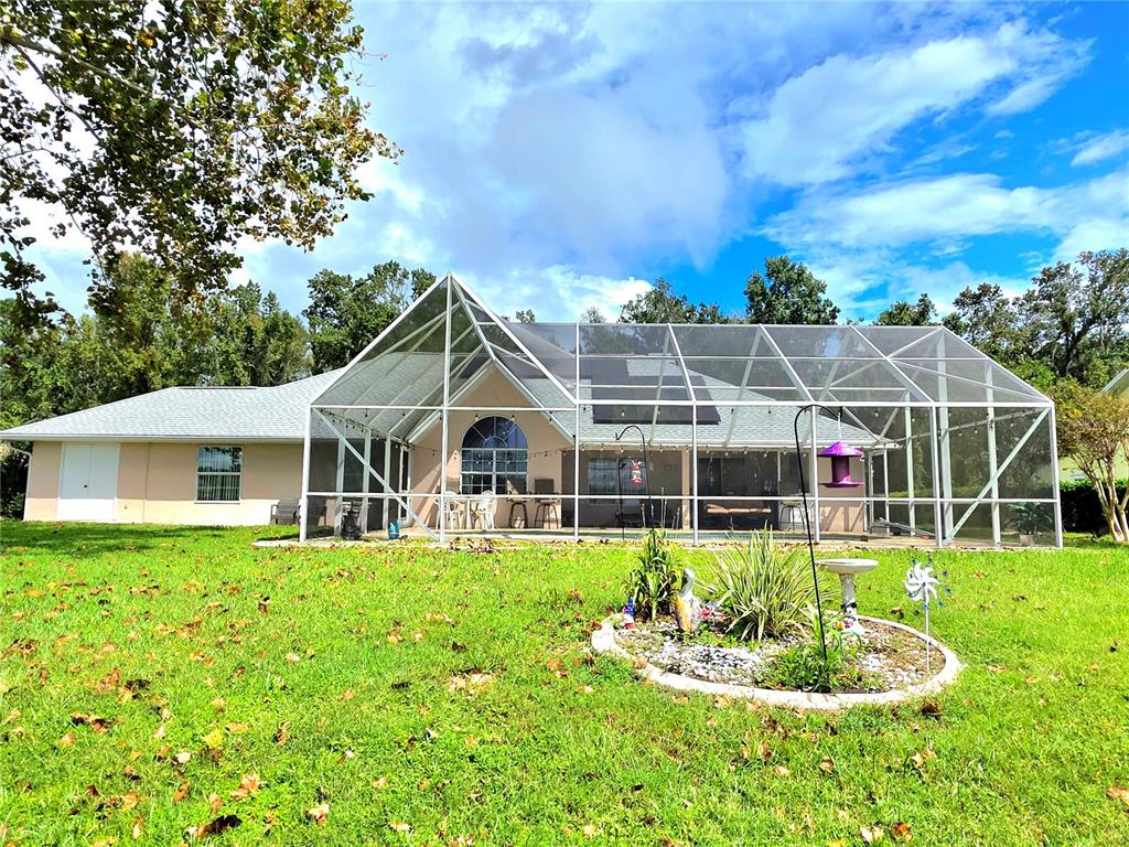 93 Hickory Loop Ocala, FL 34472 - Photo 2 of 23 a front view of a house with a yard table and chairs