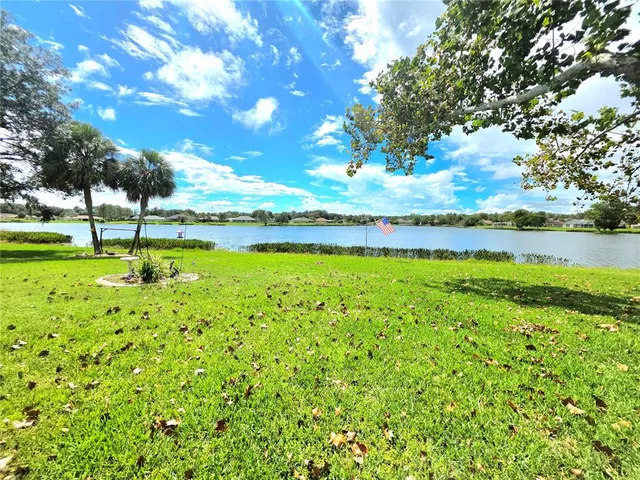 a view of yard with swimming pool and green space