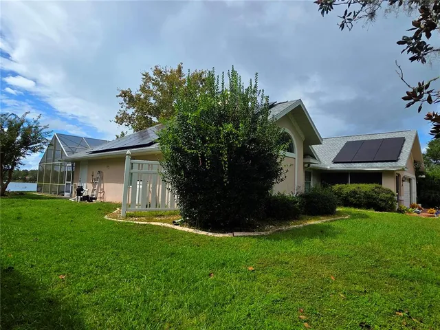 a front view of house with a garden