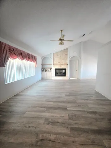 a view of empty room with fireplace and cabinet