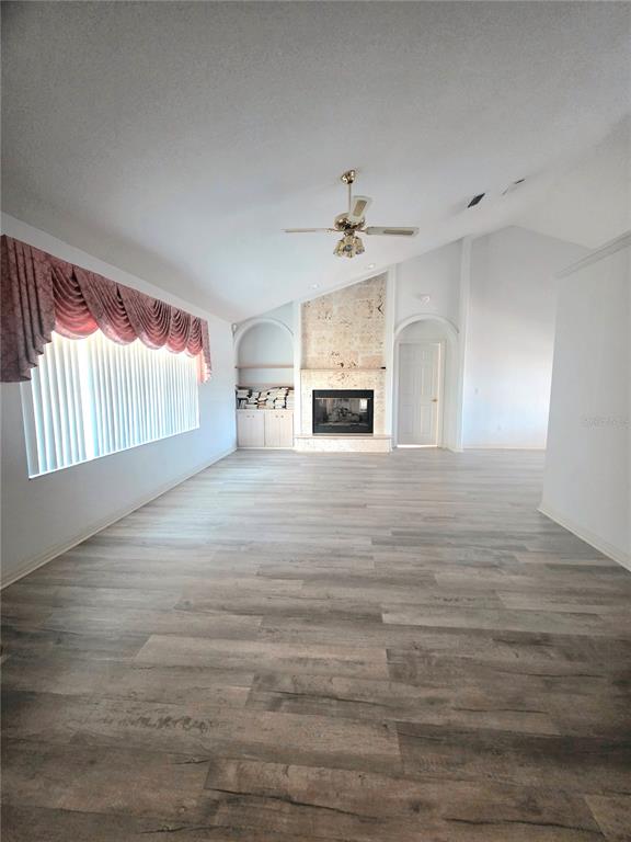 93 Hickory Loop Ocala, FL 34472 - Photo 4 of 23 a view of empty room with fireplace and cabinet