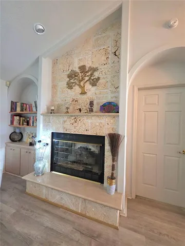 a living room with a fireplace and a window
