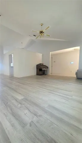 a view of a livingroom with a stove and a ceiling fan