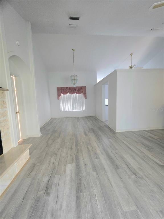 93 Hickory Loop Ocala, FL 34472 - Photo 7 of 23 wooden floor in an empty room with a window