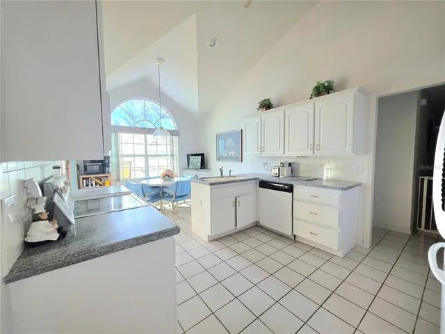 a kitchen that has a lot of cabinets in it and appliances