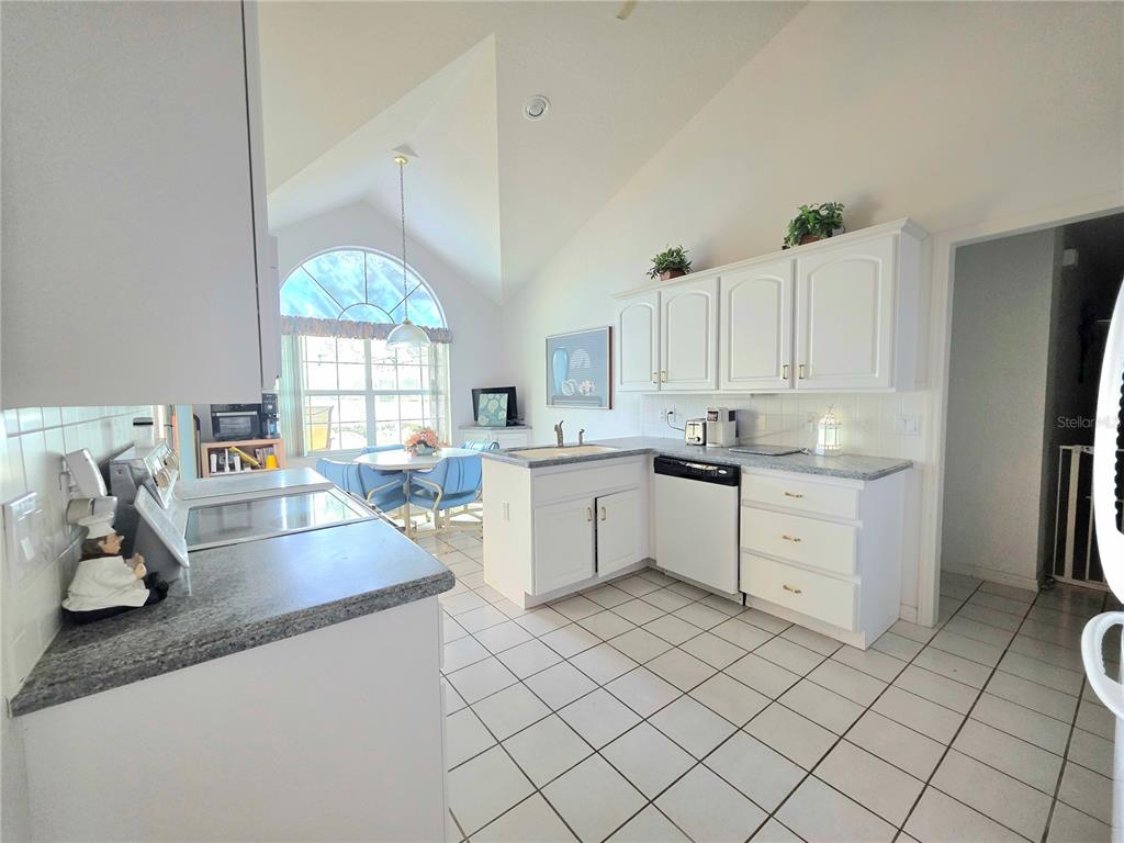 93 Hickory Loop Ocala, FL 34472 - Photo 10 of 23 a kitchen that has a lot of cabinets in it and appliances