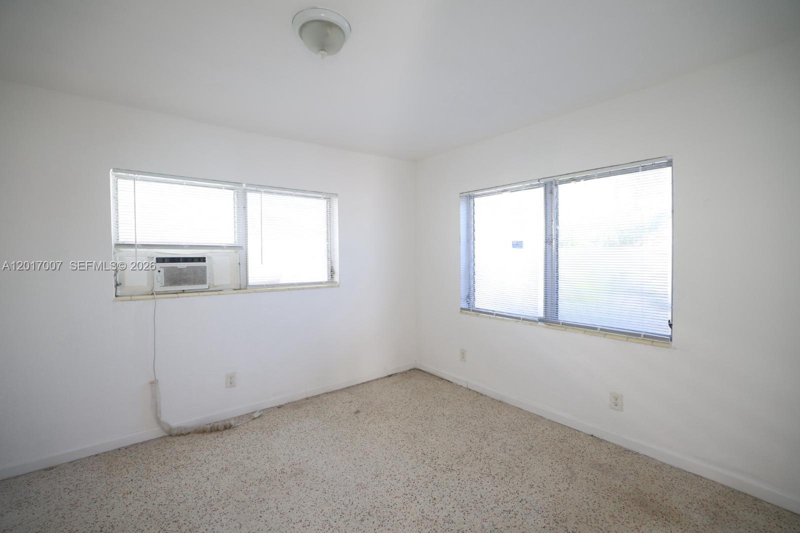 800 83rd Street, Unit 2 Miami Beach, FL 33141 - Photo 6 of 10 an empty room with a window