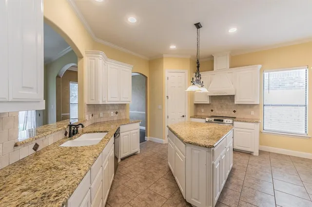 a kitchen with a sink stove and refrigerator