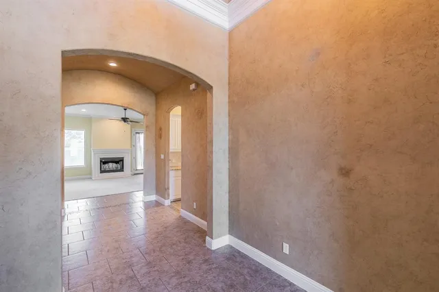 a view of a hallway with wooden floor and a fireplace