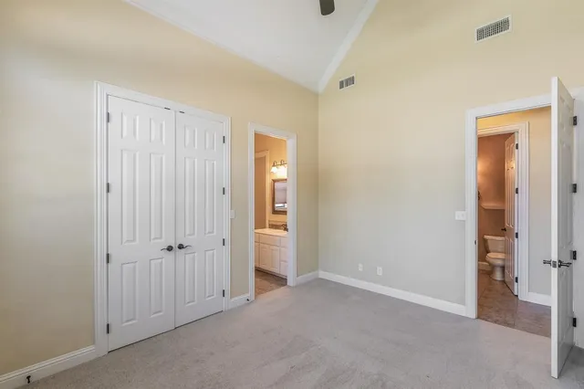 an empty room with closet and a bathroom