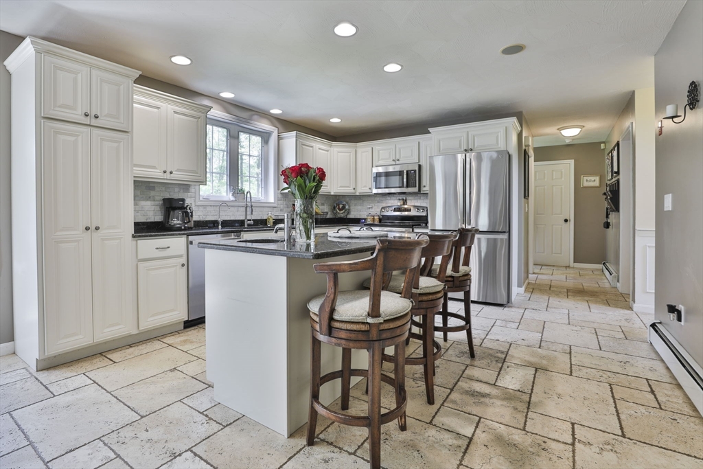 32 Glance Road Windham, NH 03087 - Photo 13 of 42 a kitchen with stainless steel appliances kitchen island granite countertop a stove a refrigerator and a refrigerator