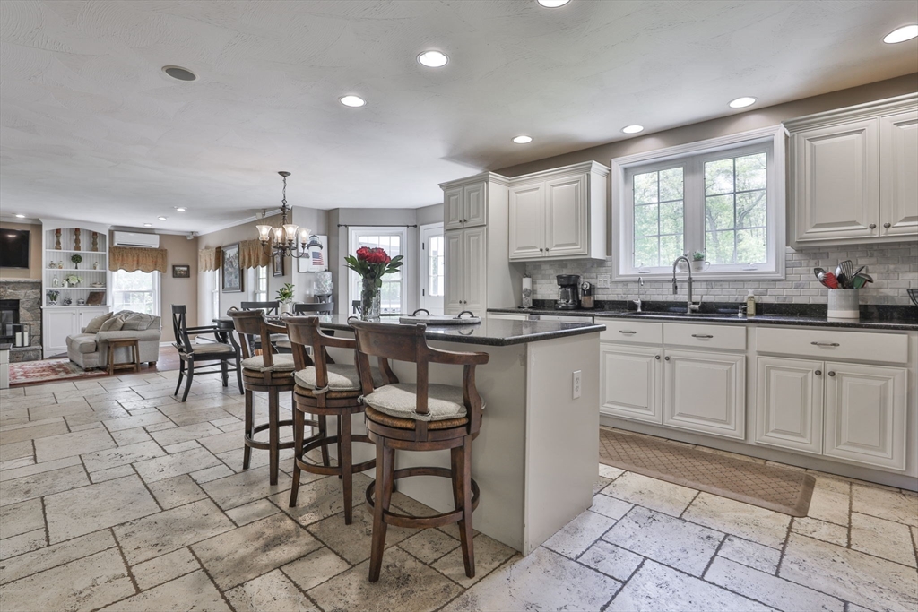 32 Glance Road Windham, NH 03087 - Photo 14 of 42 a kitchen with stainless steel appliances kitchen island granite countertop a sink and cabinets