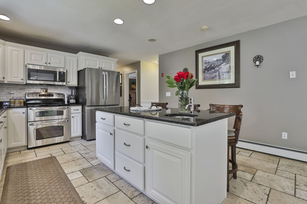 32 Glance Road Windham, NH 03087 - Photo 15 of 42 a kitchen with stainless steel appliances a sink stove and refrigerator