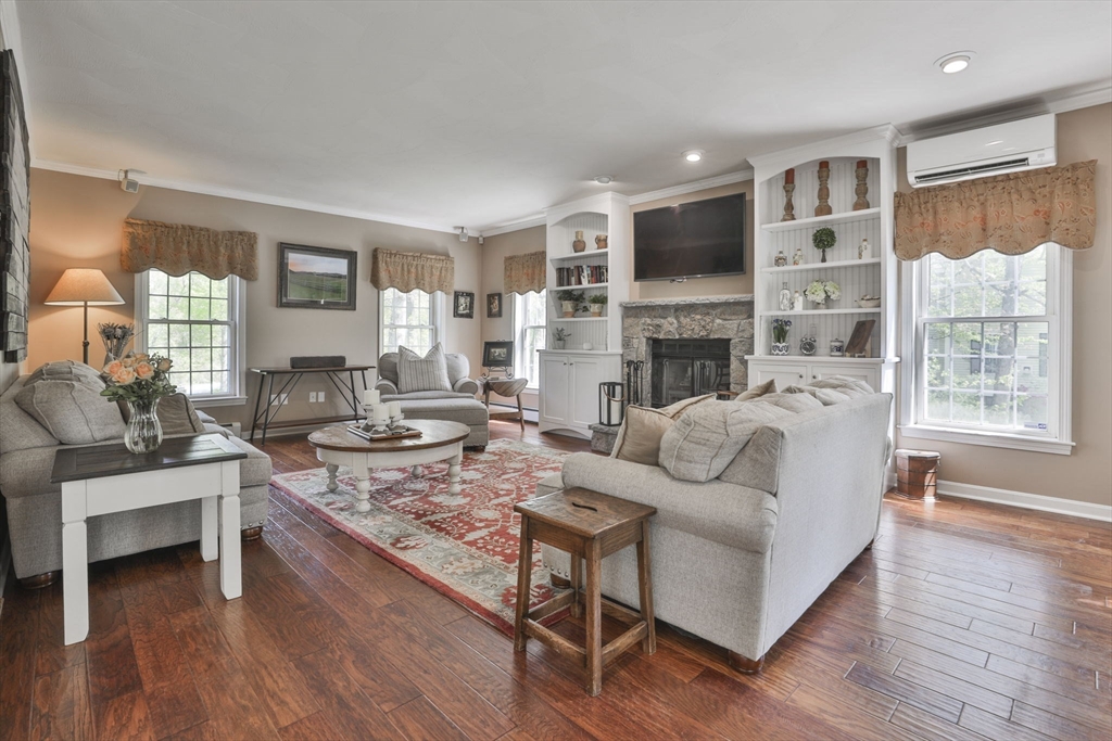 32 Glance Road Windham, NH 03087 - Photo 18 of 42 a living room with fireplace furniture and a wooden floor