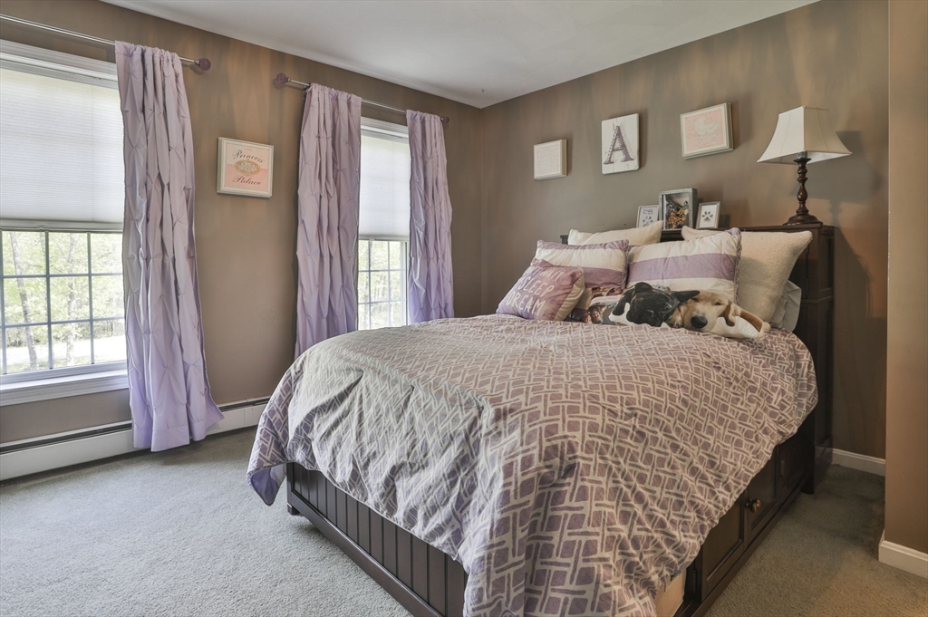 32 Glance Road Windham, NH 03087 - Photo 25 of 42 a bed sitting in a bedroom next to a window