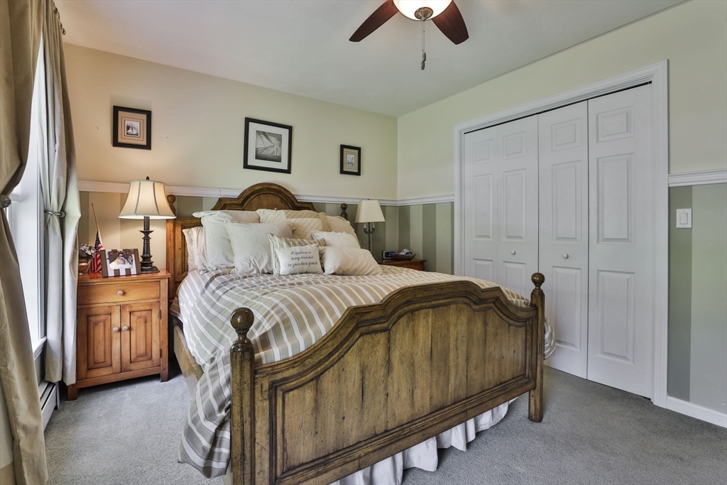 32 Glance Road Windham, NH 03087 - Photo 26 of 42 a bedroom with a bed and a chandelier