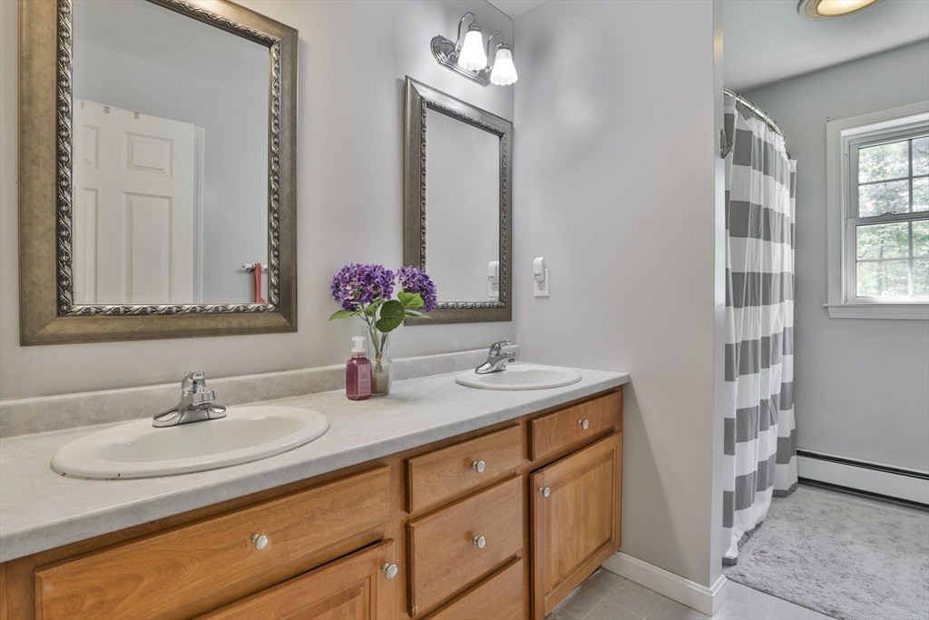 32 Glance Road Windham, NH 03087 - Photo 28 of 42 a bathroom with a sink double vanity and a mirror