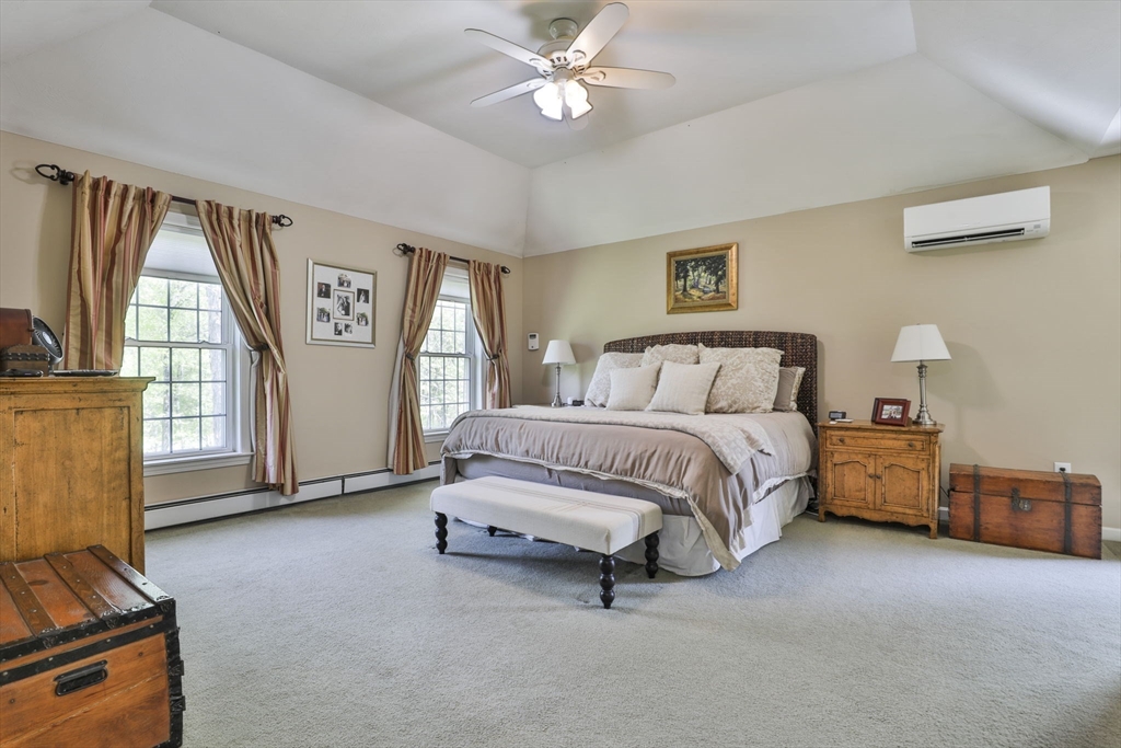 32 Glance Road Windham, NH 03087 - Photo 29 of 42 a spacious bedroom with a bed and a chandelier