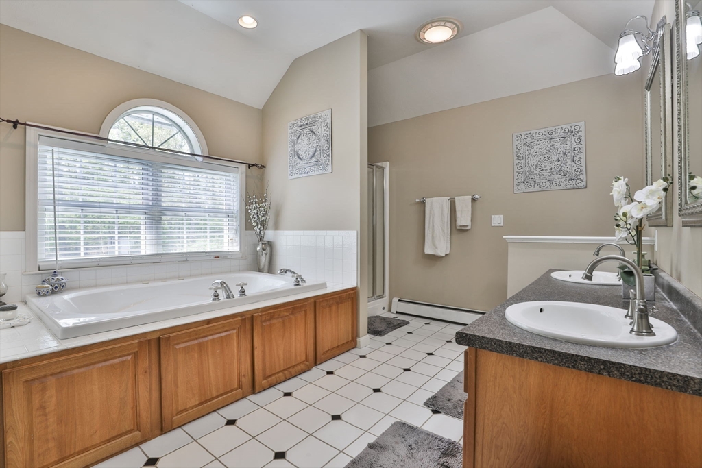 32 Glance Road Windham, NH 03087 - Photo 31 of 42 a spacious bathroom with a tub sink and mirror