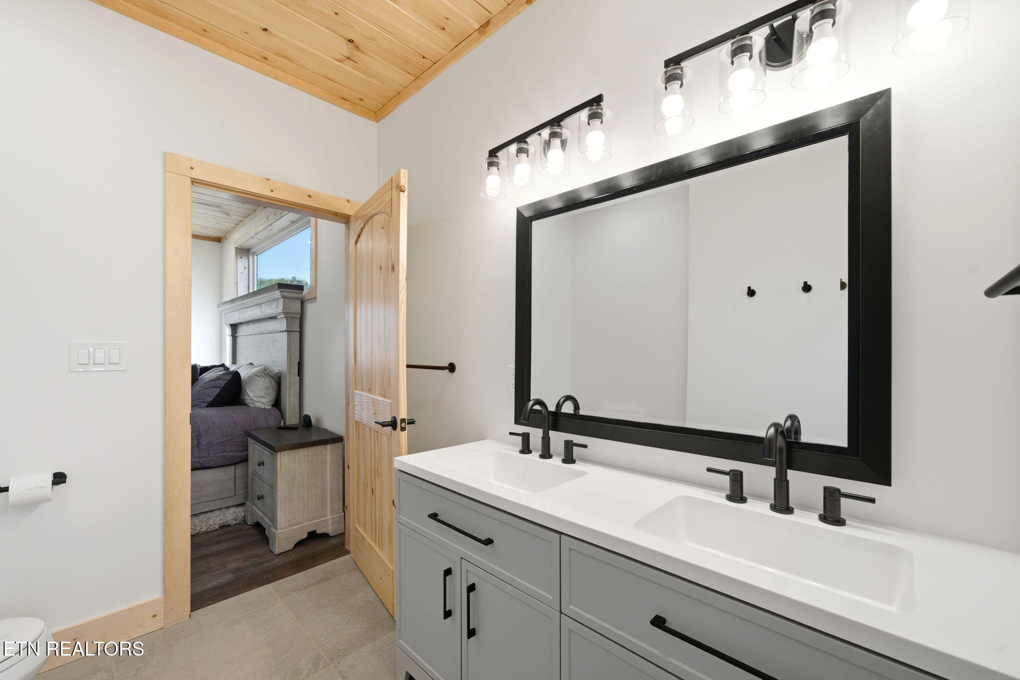 644 Ridge Top Loop Gatlinburg, TN 37738 - Photo 17 of 32 a en suite bathroom with a double vanity sink and mirror