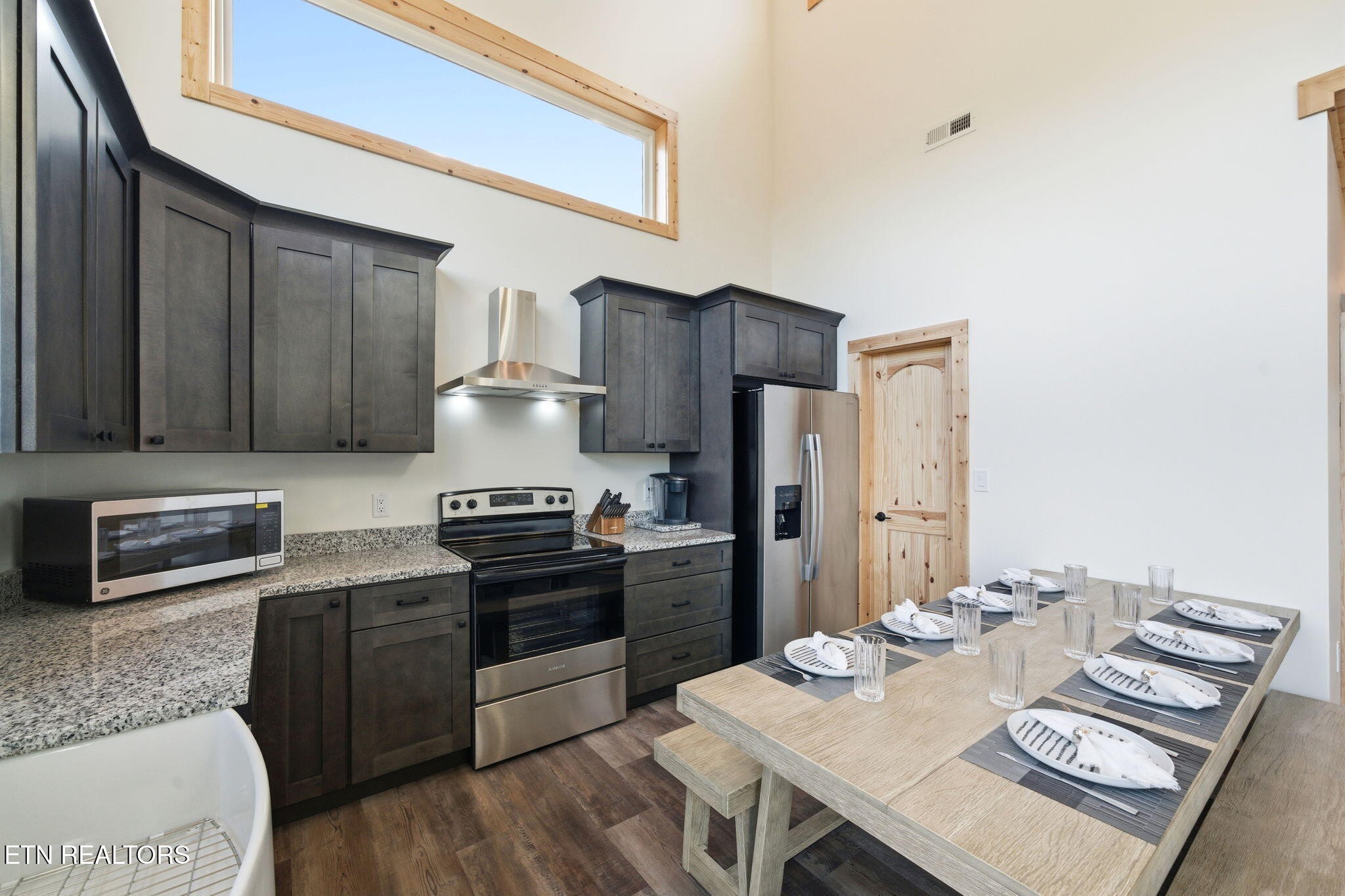 644 Ridge Top Loop Gatlinburg, TN 37738 - Photo 9 of 32 a kitchen with stainless steel appliances granite countertop a stove refrigerator and a stove