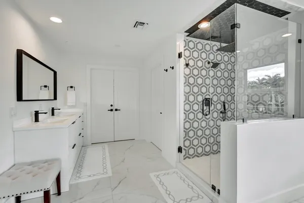 a view of a patio with table and chairs and potted plants with wooden fence