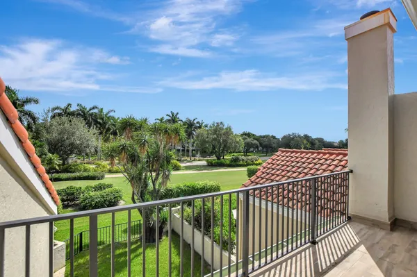 a view of a house with a big yard and sitting area