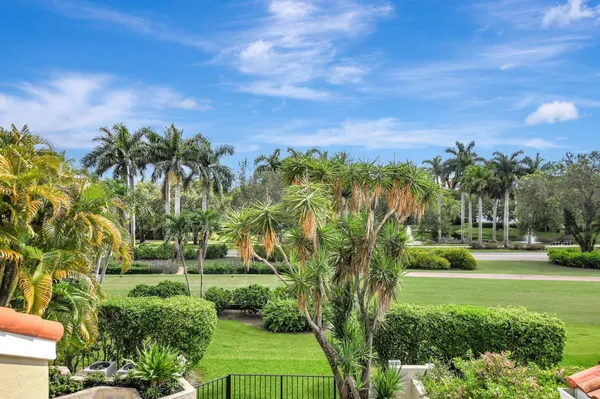 a view of a swimming pool and a yard in the background