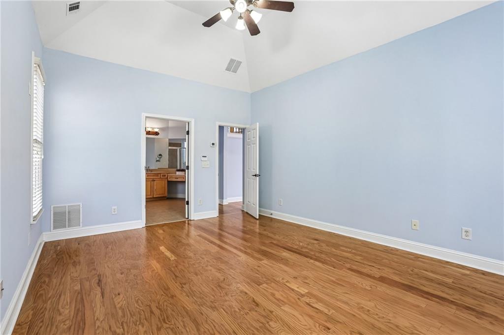 810 Freedom Way Cumming, GA 30040 - Photo 20 of 61 a view of an empty room with a ceiling fan window and a kitchen