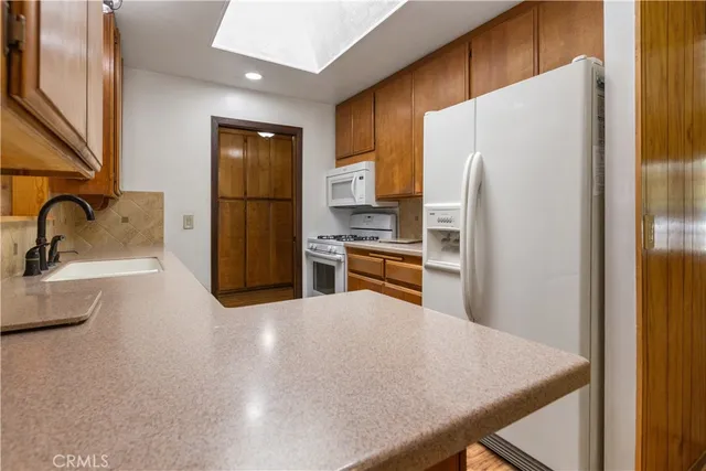 a kitchen with stainless steel appliances a refrigerator and sink